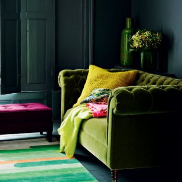Dark-Living-room-with-Green-velvet-Couch-Red